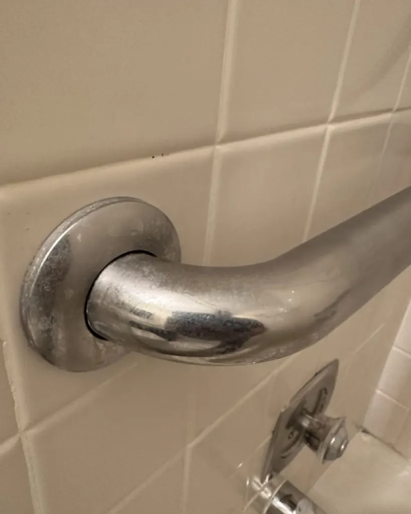 Before: shower grab bar before cleaning