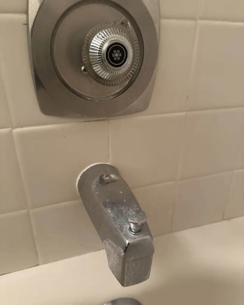 Before: tub spout before cleaning