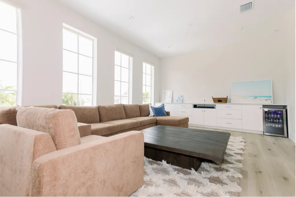 Clean family room with sectional sofa and rug